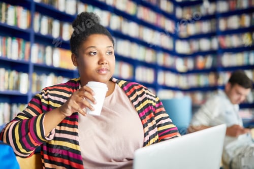 Preview: Woman has coffee break at library