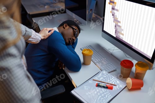 Preview: Woman looks on sleeping manager, night office