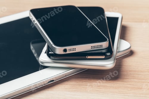 Preview: Digital tablet and mobile phone. Electronic devices on wooden table, close up
