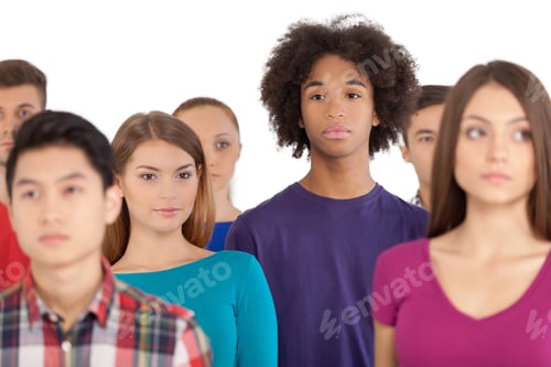 Preview: Loneliness in a crowd. Frustrated African teenager standing among people and looking away