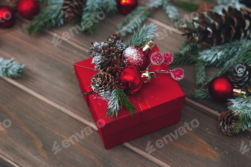 Preview: red festive winter box with handmade decor on wooden old table fir branches, pine cones and toys