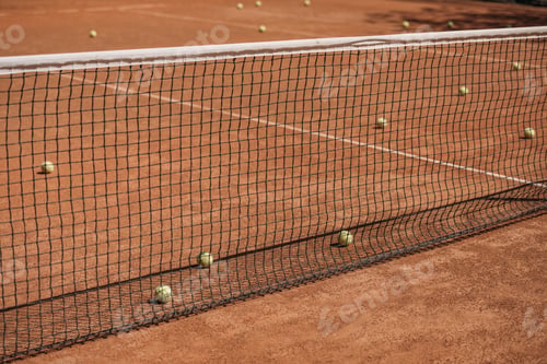 Preview: messy tennis balls lying on court outdoors