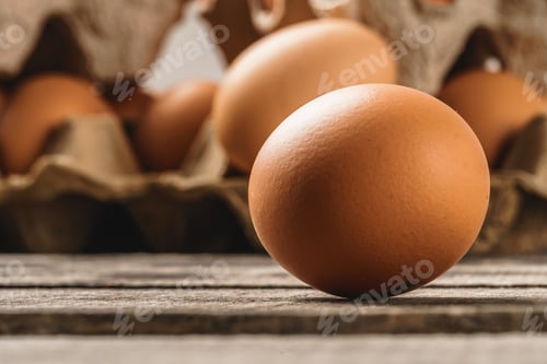 Preview: Close up of fresh chicken egg on nature wooden table