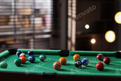 Preview: Many colorful billiard balls on green table indoors, space for text