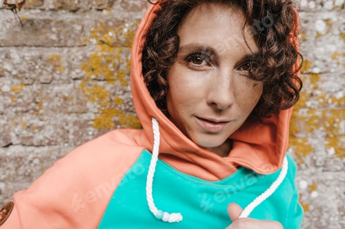 Preview: Portrait of woman wearing hoodie outdoors