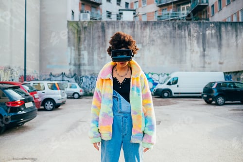 Preview: Young black stylish woman outdoor using 3D goggles augmented reality