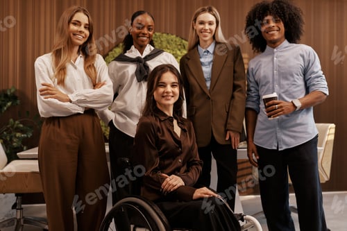 Preview: Diverse Team Portrait with Smiling Woman in Wheelchair at Office