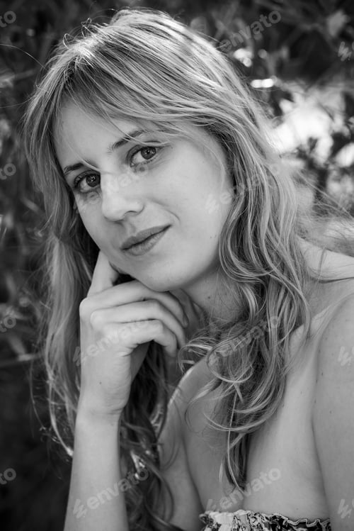 Preview: Black & white shot of a blonde girl posing in a park or natural area.