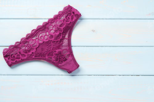 Preview: Top view women's underwear panties on a wooden background.