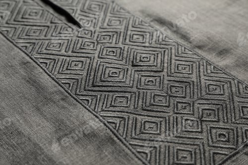 Preview: Black shirt with beautiful embroidery design as background, closeup. Ukrainian national clothes