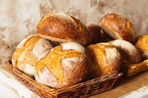 Preview: Delicious fresh breads in wicker baskets placed on wooden table