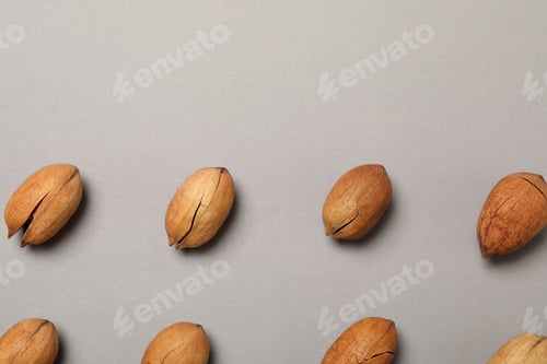 Preview: Flat lay with tasty pecan nuts on gray background