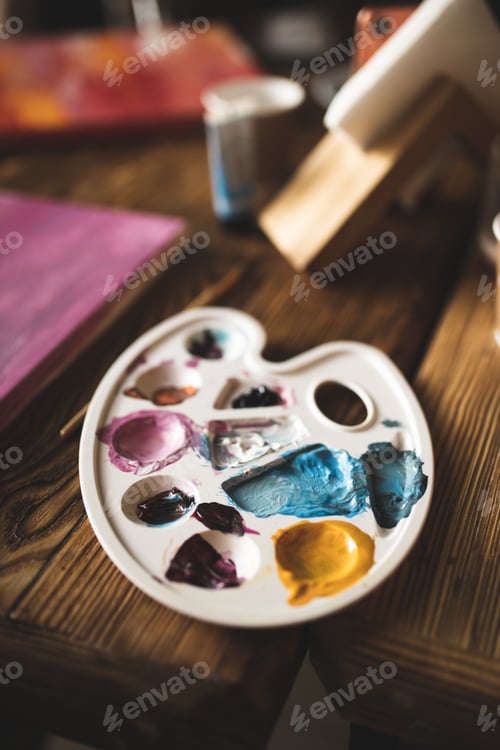 Preview: Colorful Paint on Palette on Wooden Table