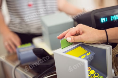 Preview: Woman putting credit card into reader