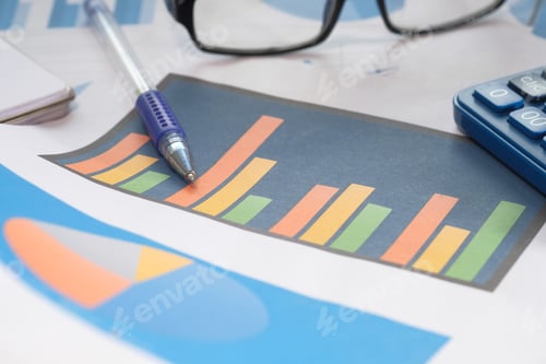 Preview: Close up of financial chart and pens on table