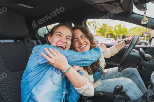 Preview: Happy young women embracing inside car enjoying friendship, caregiver concept