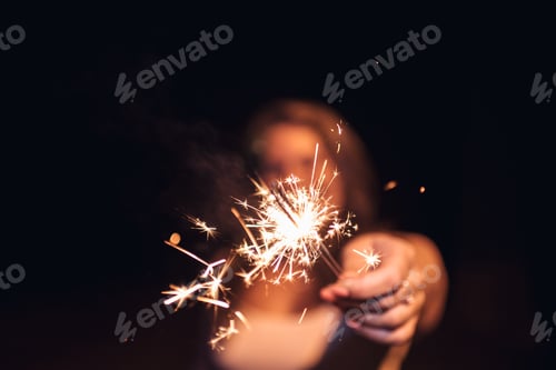 Preview: Woman Holding Sparklers Celebrating New Year's Eve