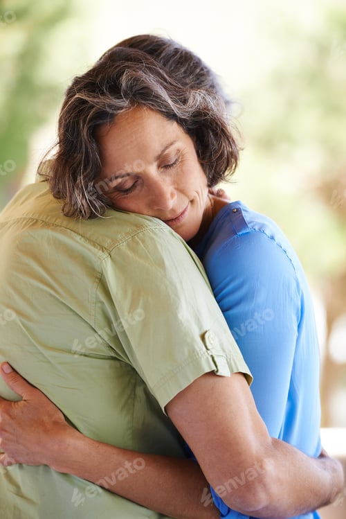 Preview: Safe in loves arms. A cropped shot of an affectionate couple embracing outdoors.