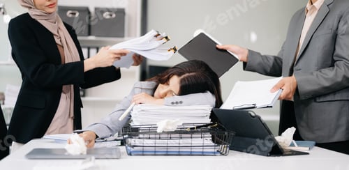 Preview: Stressed Asian Businesswoman Surrounded by Overwhelming Paperwork Concept