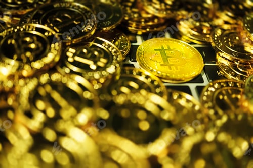 Preview: Bitcoin background. Golden bitcoin on keyboard.