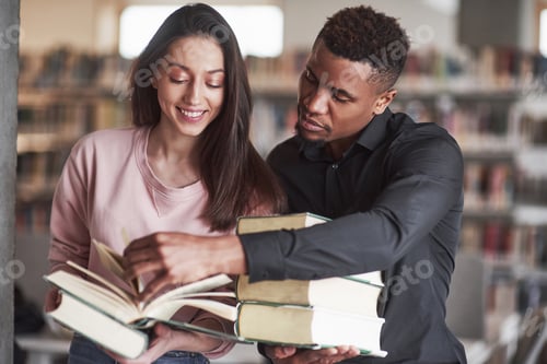 Preview: Let me help you. Multiracial students in the library searching for the information together