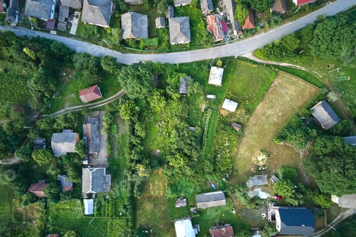 Preview: Aerial landscape view of village houses and distant green cultivated agricultural fields