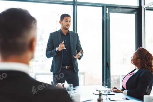 Preview: Cropped shot of a handsome young businessman giving a presentation in the boardroom