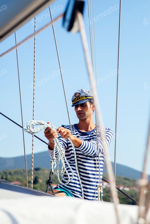Preview: Handsome young man on a sailboat
