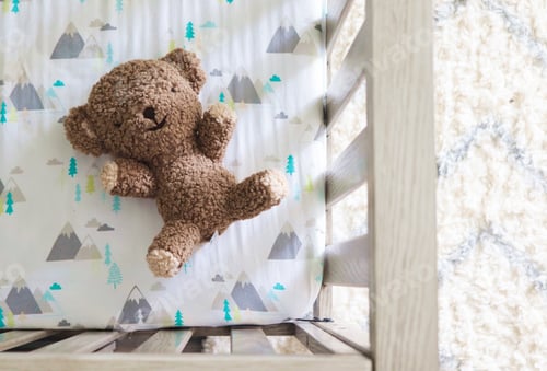 Preview: Teddy Bear stuffed animal in a baby’s crib top view