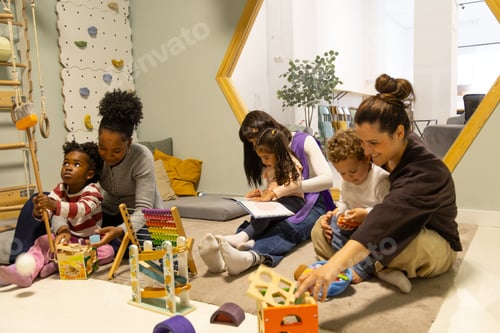 Preview: Diverse children and teachers learning playing in nursery