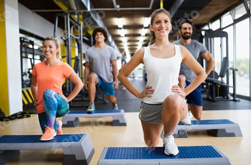 Preview: Portrait of happy fit group of people working out in gym together