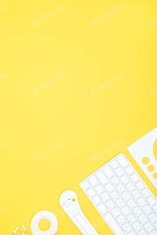 Preview: Flat lay of office supplies, keyboard and stationery knife with copy space on yellow