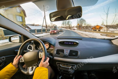 Preview: Modern car interior with driver female hands on steering wheel