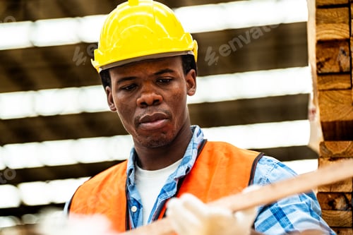 Preview: african man checking the quality of wooden products at workshop