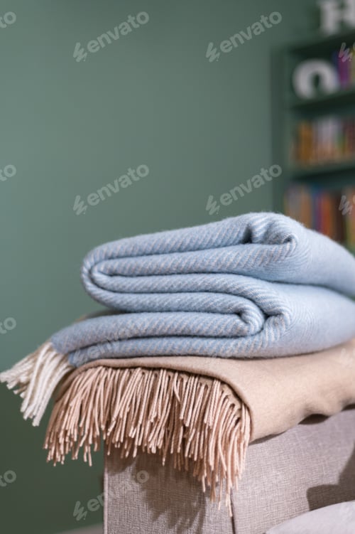 Preview: Stack of woolen checked blankets
