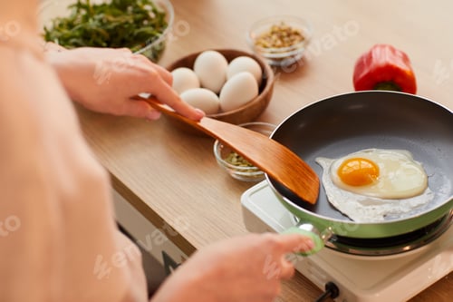 Preview: Woman Frying Eggs for Breakfast