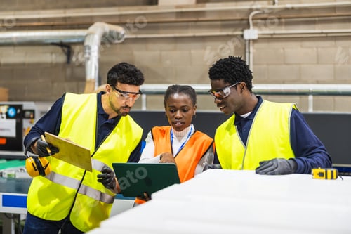 Preview: Diverse industrial workers collaborating on a project controlling production