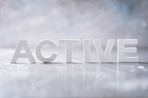 Preview: Word ACTIVE made with cement letters on grey marble background. Copy space. Business concept