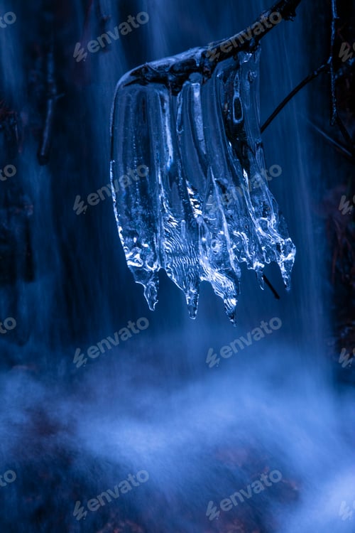 Preview: Icicles on branch near waterfall