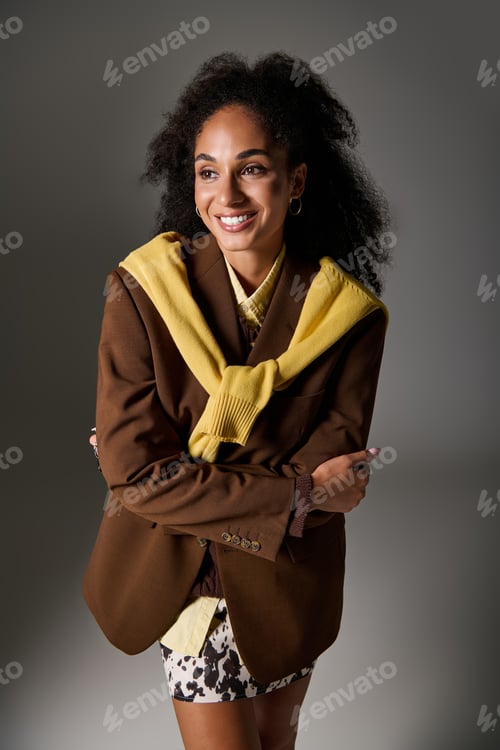 Preview: Elegant autumn fashion showcased by a confident black woman in a studio setting