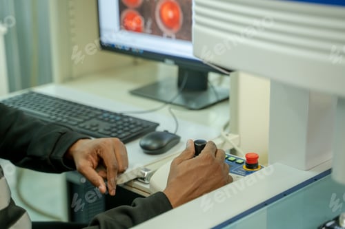 Preview: Engineer programming the machine in factory with laptop computer to setup program process.