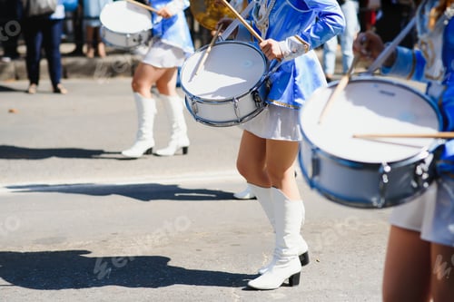 Preview: majorettes with white and blue uniforms perform in the streets of the city. photographic series