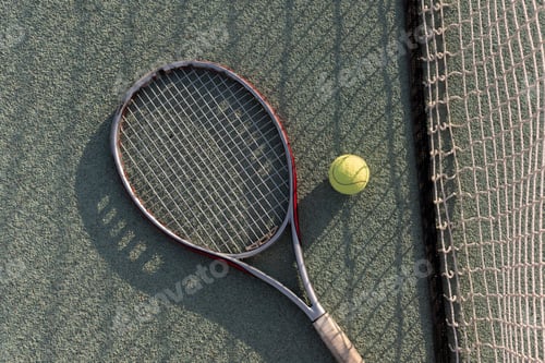 Preview: tennis racquet and ball lie on a clay tennis court, ready for a game