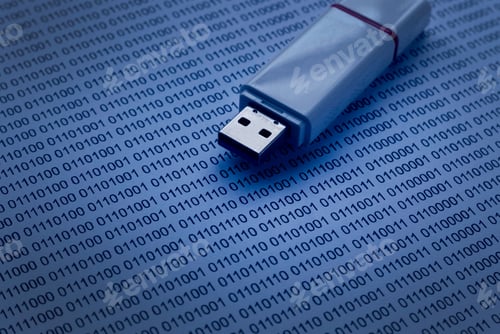 Preview: Selective focus of usb drive on a paper of binary code.