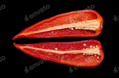 Preview: Red kapia pepper cut in two on a black background