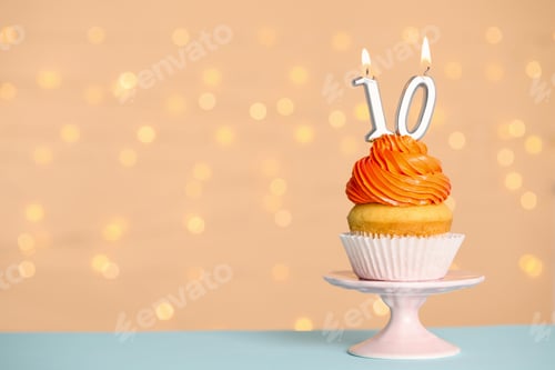 Preview: Birthday cupcake with number ten candle on stand against festive lights, space for text