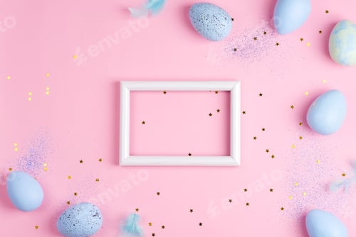 Preview: Corner frame from handmade painted eggs of pastel blue colors, photo frame and light feathers on a