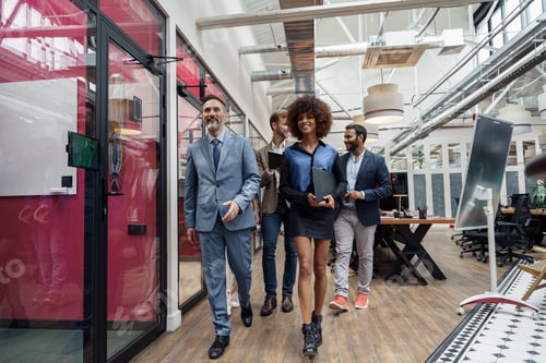 Preview: Group of multiethnic business people crossing office together