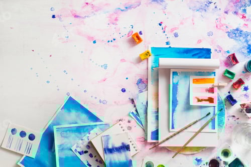 Preview: Artistic Watercolor Paints and Notebooks on Painted Background