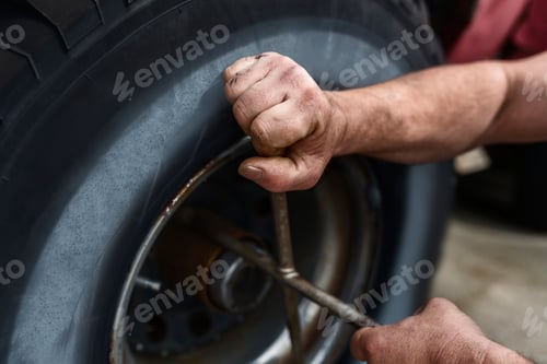 Preview: Hands of mature man repairing car
